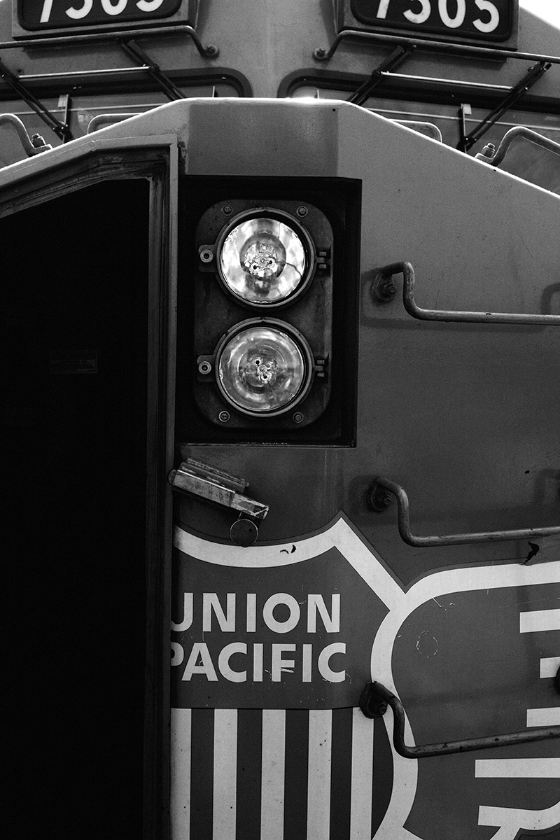 close up black and white photo of a union pacific freight train
