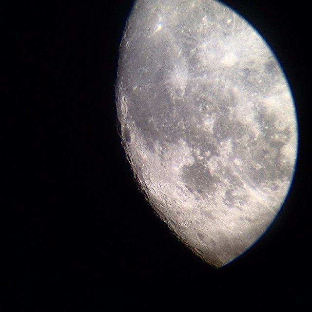 the moon as seen thorugh the eyepiece of a 90mm refractor telescope