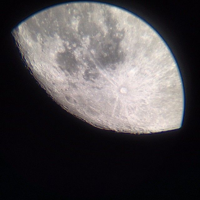 the moon as seen thorugh the eyepiece of a 90mm refractor telescope